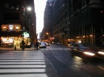 City street at dusk with traffic.