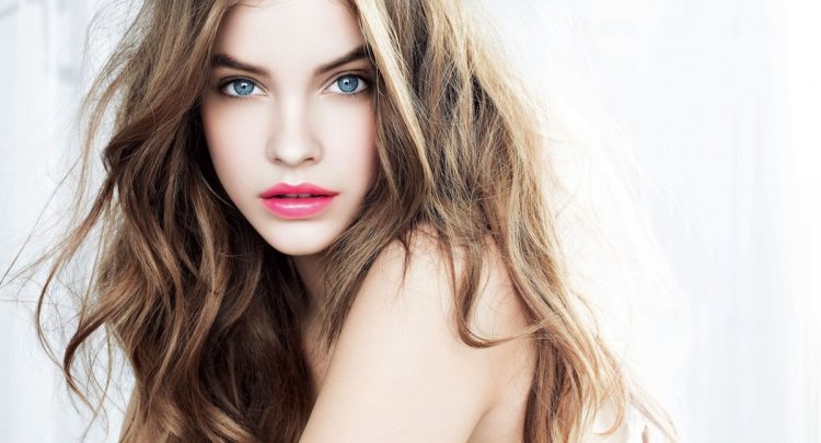 A beautiful young lady with long, wavy hair.