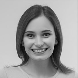 A black and white photo of a woman smiling.