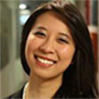 A woman smiling for the camera with long hair.