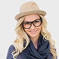 A woman wearing glasses and a hat.