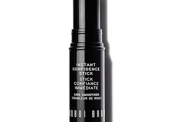 A black and white photo of a stick of lipstick.