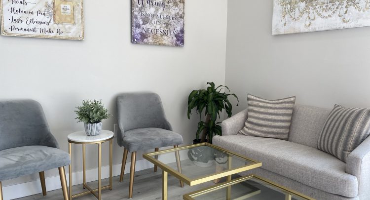 A living room with four chairs and two tables