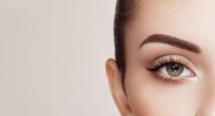A close up of a woman 's eye with long lashes
